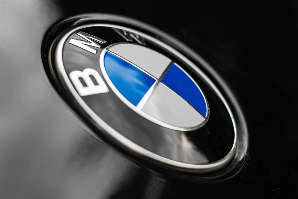 Close-up shot of luxury car brand BMW logo on car body work