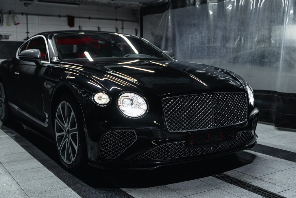 Black Bentley Continental GT parked in a car wash