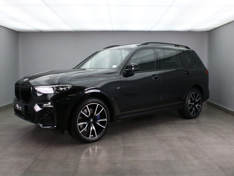 Black BMW X5 M SUV shown in a clean showroom, front three-quarter view.