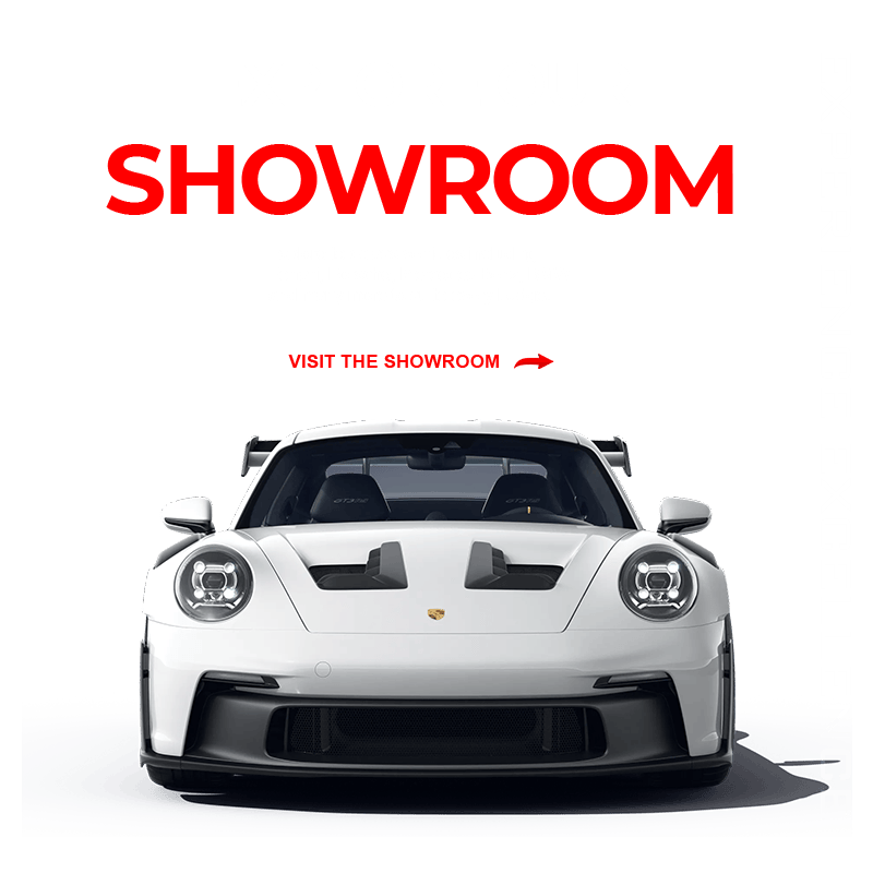 Promotional banner: white Porsche front view on a green background with bold red 'SHOWROOM' and vertical 'EXPERIENCE EXCELLENCE' text along the right edge, inviting a showroom visit.